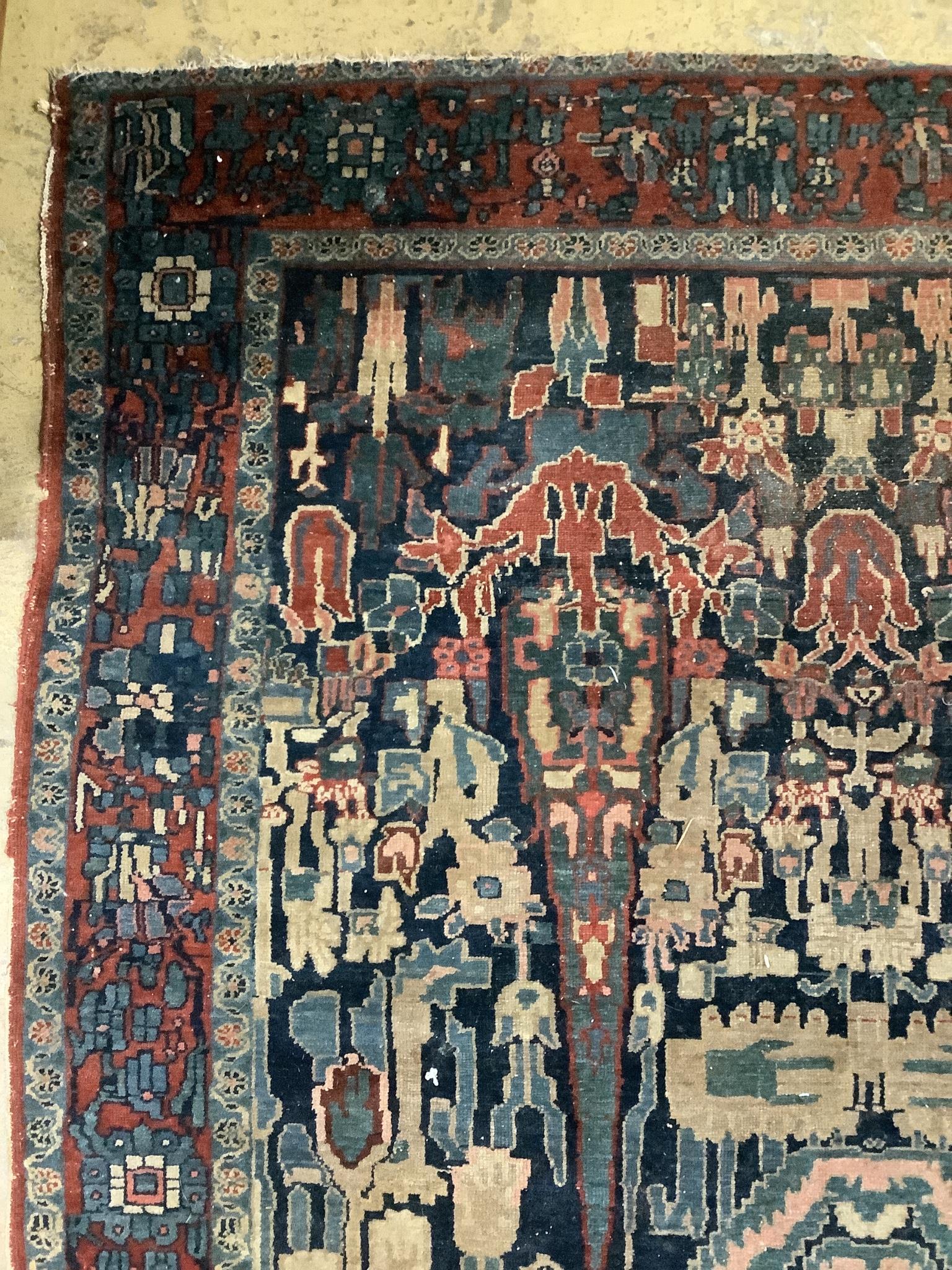 An antique Persian blue ground rug, woven with birds within a garden, 170 x 120cm